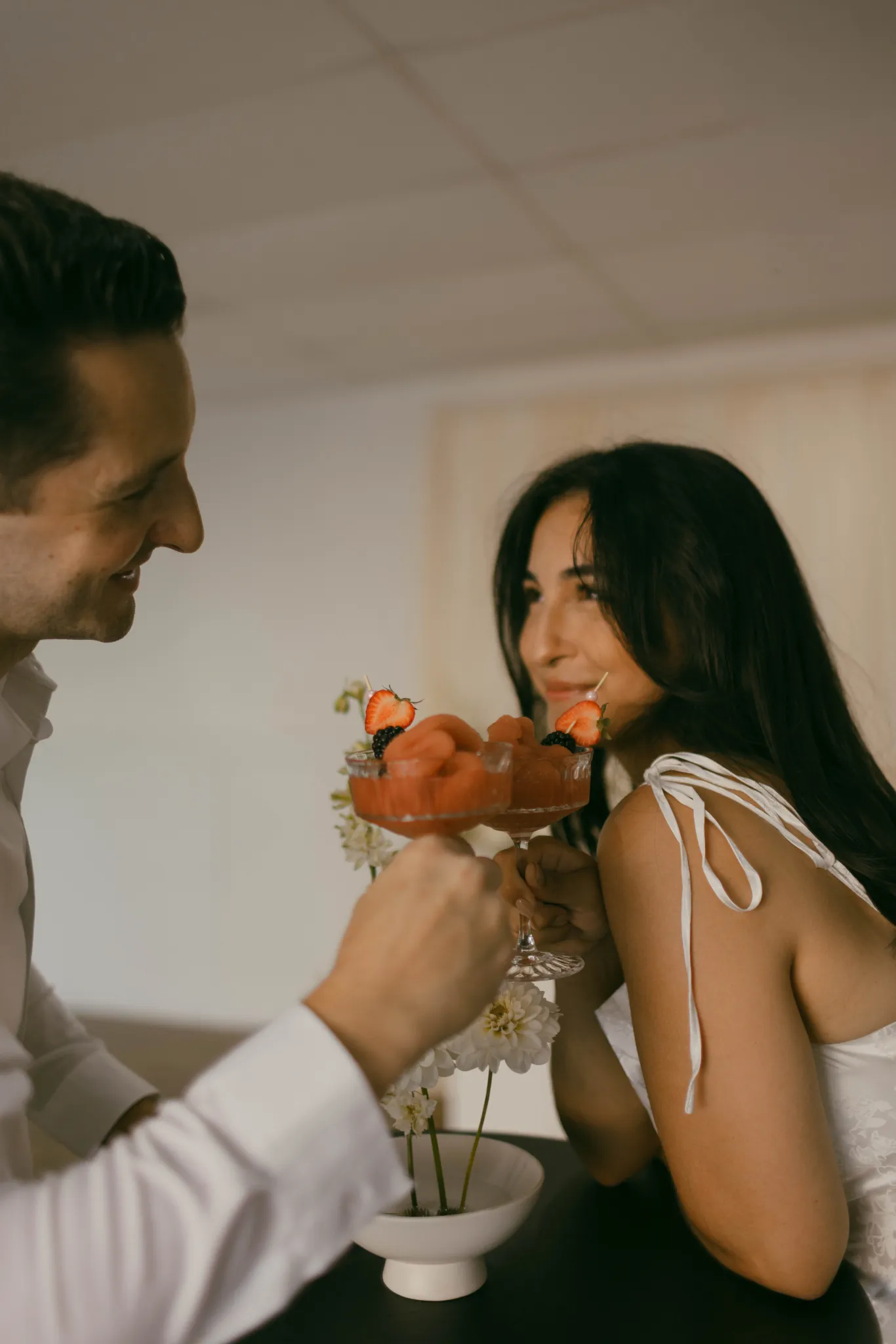 Couple toasting with Blush Fizz Co. frozen cocktails at a wedding celebration